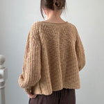 Back view of SoftSpun beige textured knit sweater with airy lightweight design