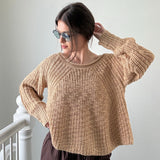Woman wearing beige textured boatneck sweater styled with casual outfit and relaxed silhouette