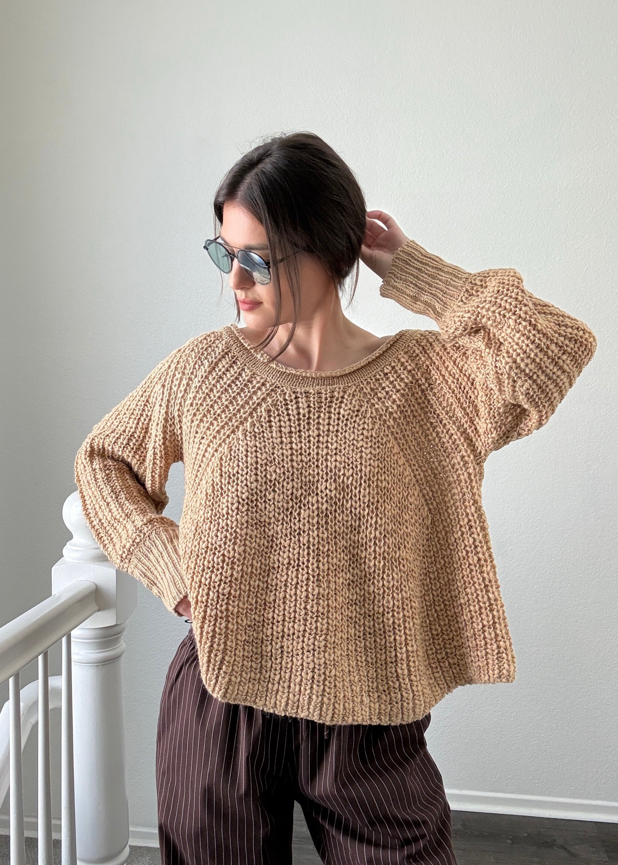 Woman wearing beige textured boatneck sweater styled with casual outfit and relaxed silhouette