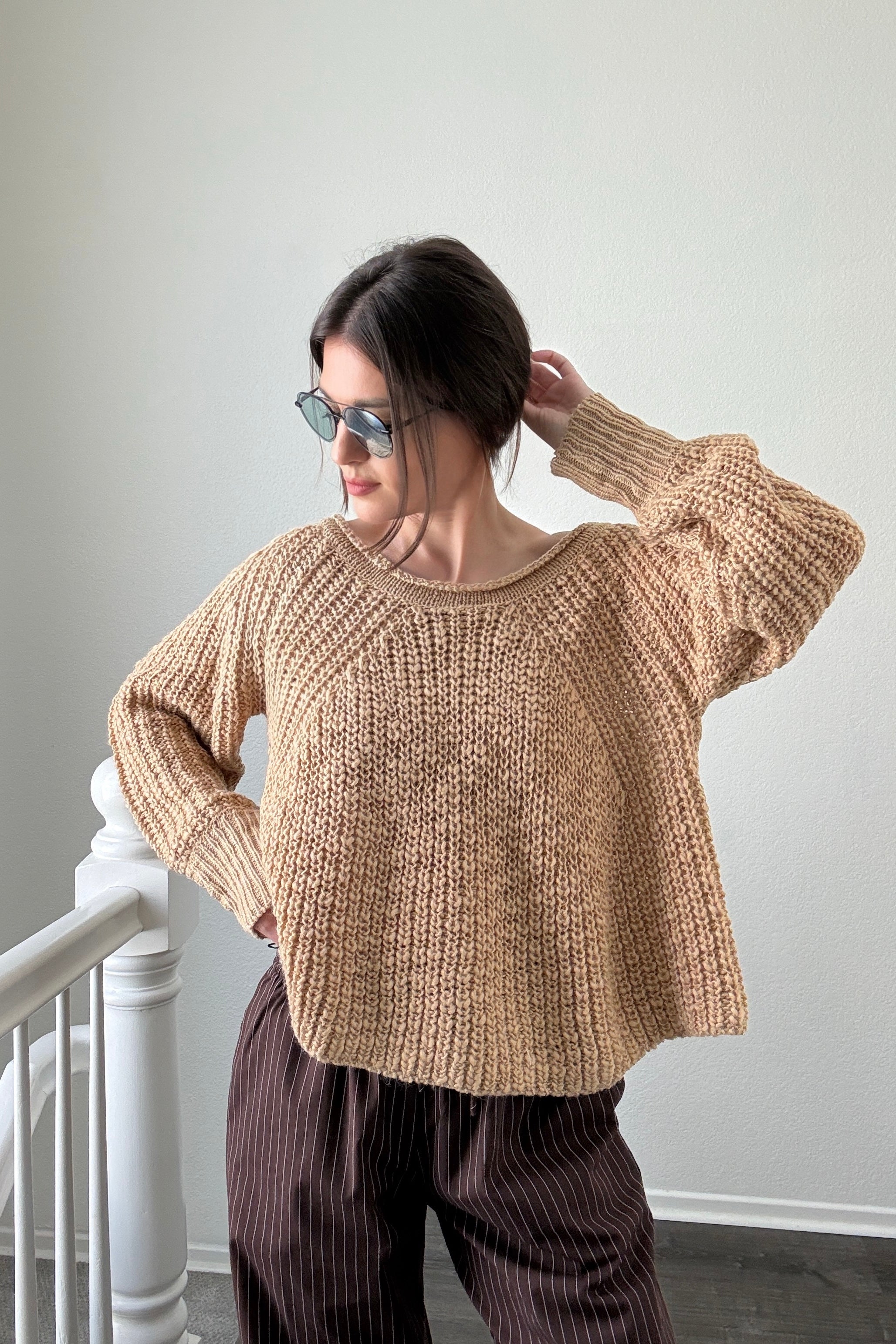 Woman wearing beige textured boatneck sweater styled with casual outfit and relaxed silhouette