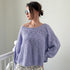Woman wearing  SoftSpun textured boatneck sweater in lavender, front view with relaxed fit and airy knit