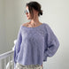 Woman wearing  SoftSpun textured boatneck sweater in lavender, front view with relaxed fit and airy knit