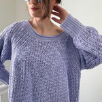 Close-up of airy textured knit on soft lavender boatneck sweater