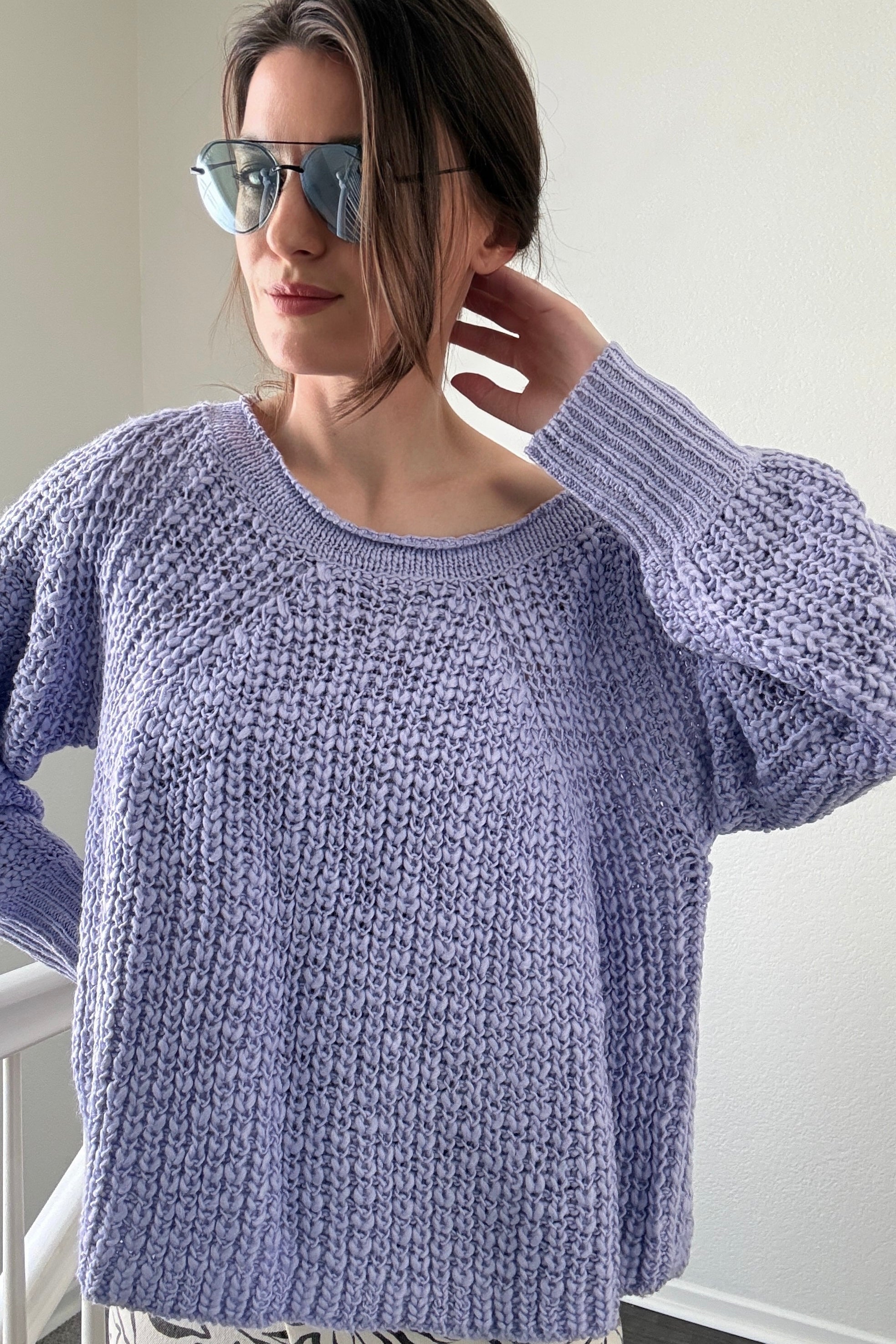 Close-up of airy textured knit on soft lavender boatneck sweater