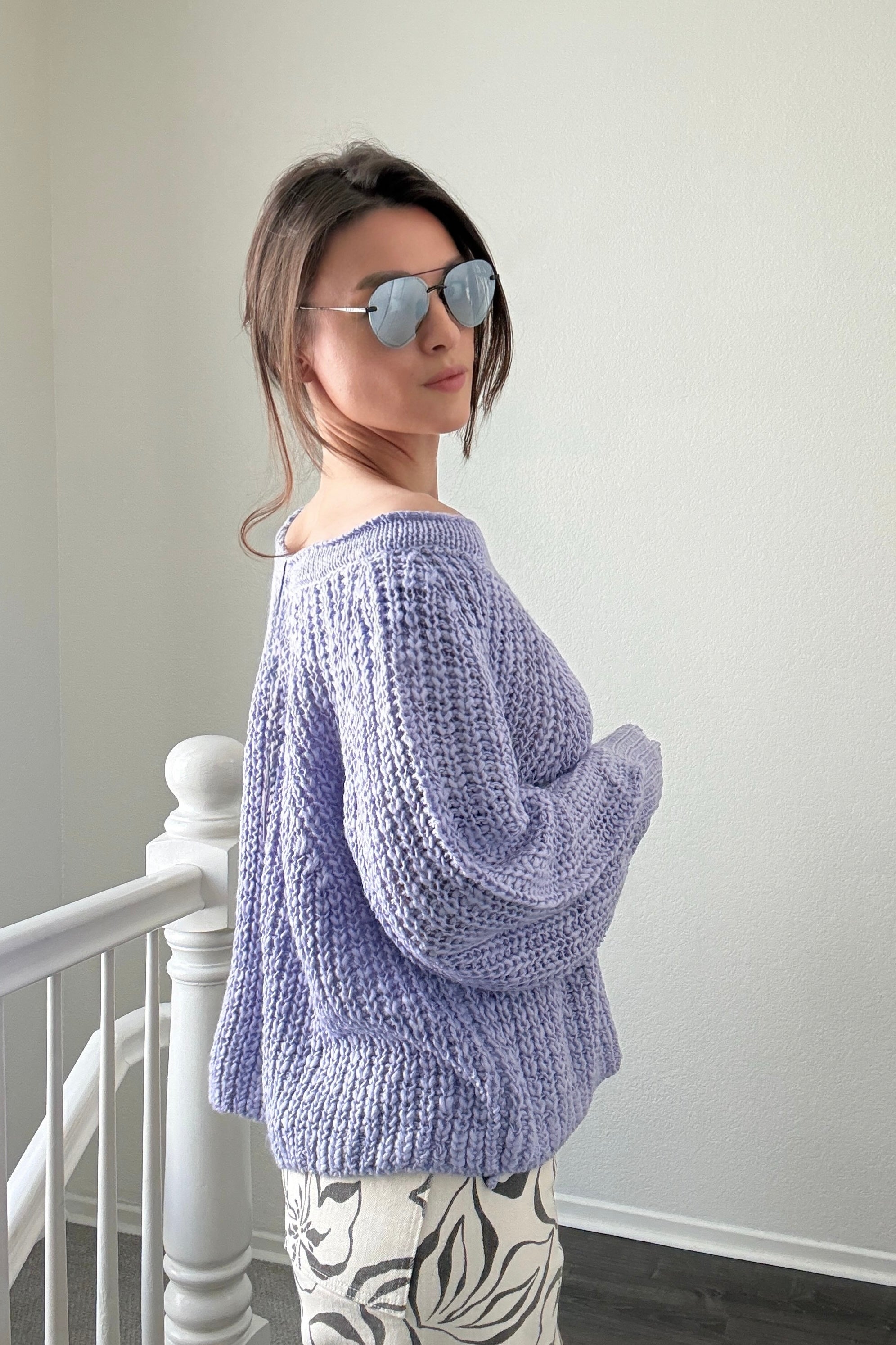 Side view of lavender textured boatneck sweater with loose knit and relaxed fit