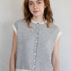Woman wearing a striped sleeveless Piper Vest Cardigan against a plain background