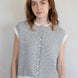Woman wearing a striped sleeveless Piper Vest Cardigan against a plain background