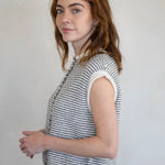 Woman wearing a sleeveless striped Hailey Piper Vest Cardigan  against a plain background