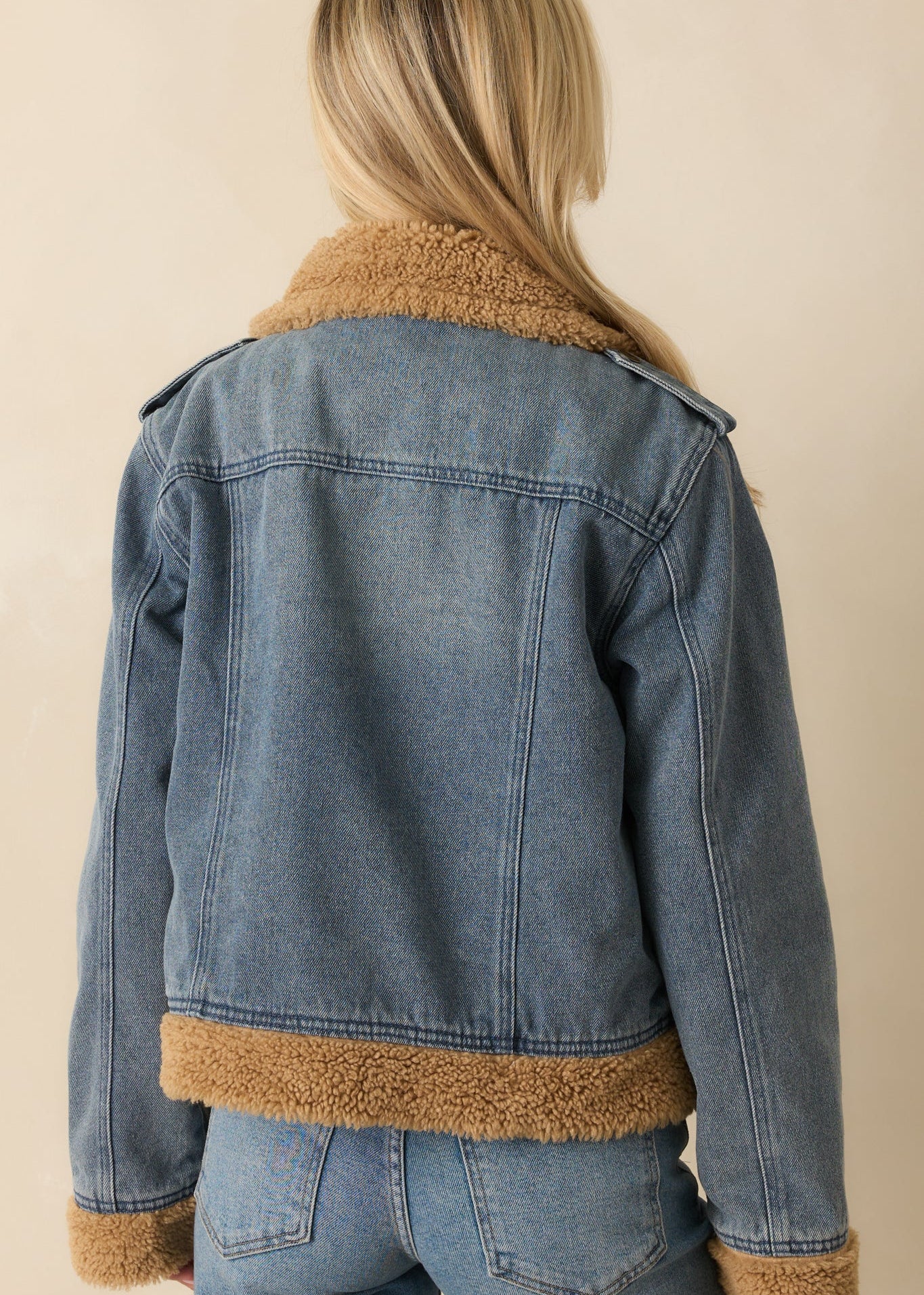 Back of teddy-lined denim jacket showing classic denim design with soft sherpa interior.