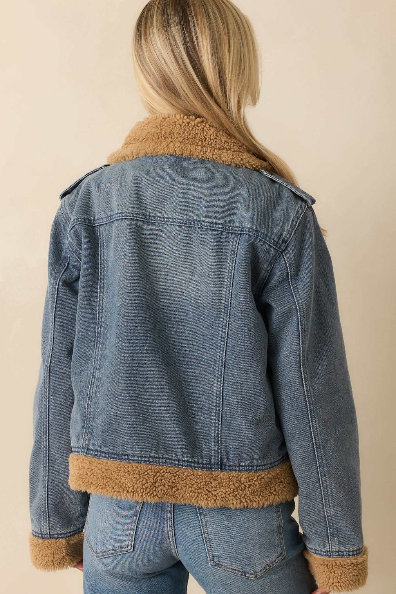 Back of teddy-lined denim jacket showing classic denim design with soft sherpa interior.
