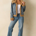 Teddy-lined denim jacket layered over knit top and jeans — casual women’s fall outfit.