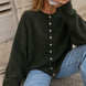 Woman wearing the Things Between Piper Cardigan in dark hunter green