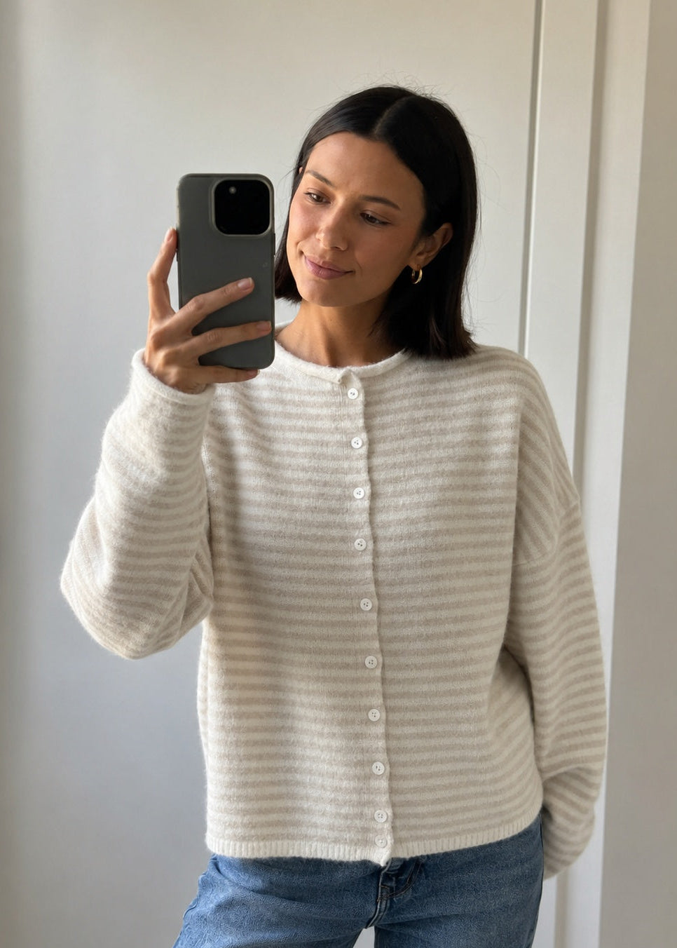 Things Between Piper Cardigan in Mini Striped Cream styled with blue jeans in mirror selfie