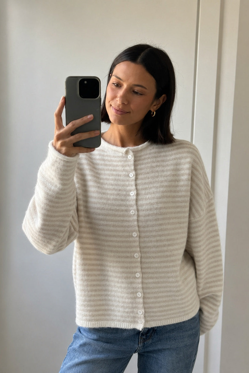 Things Between Piper Cardigan in Mini Striped Cream styled with blue jeans in mirror selfie