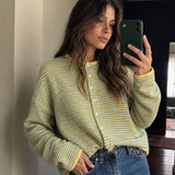 Woman wearing the Things Between Piper Cardigan in Pin-Striped Butter, front lifestyle view styled for an easy everyday outfit