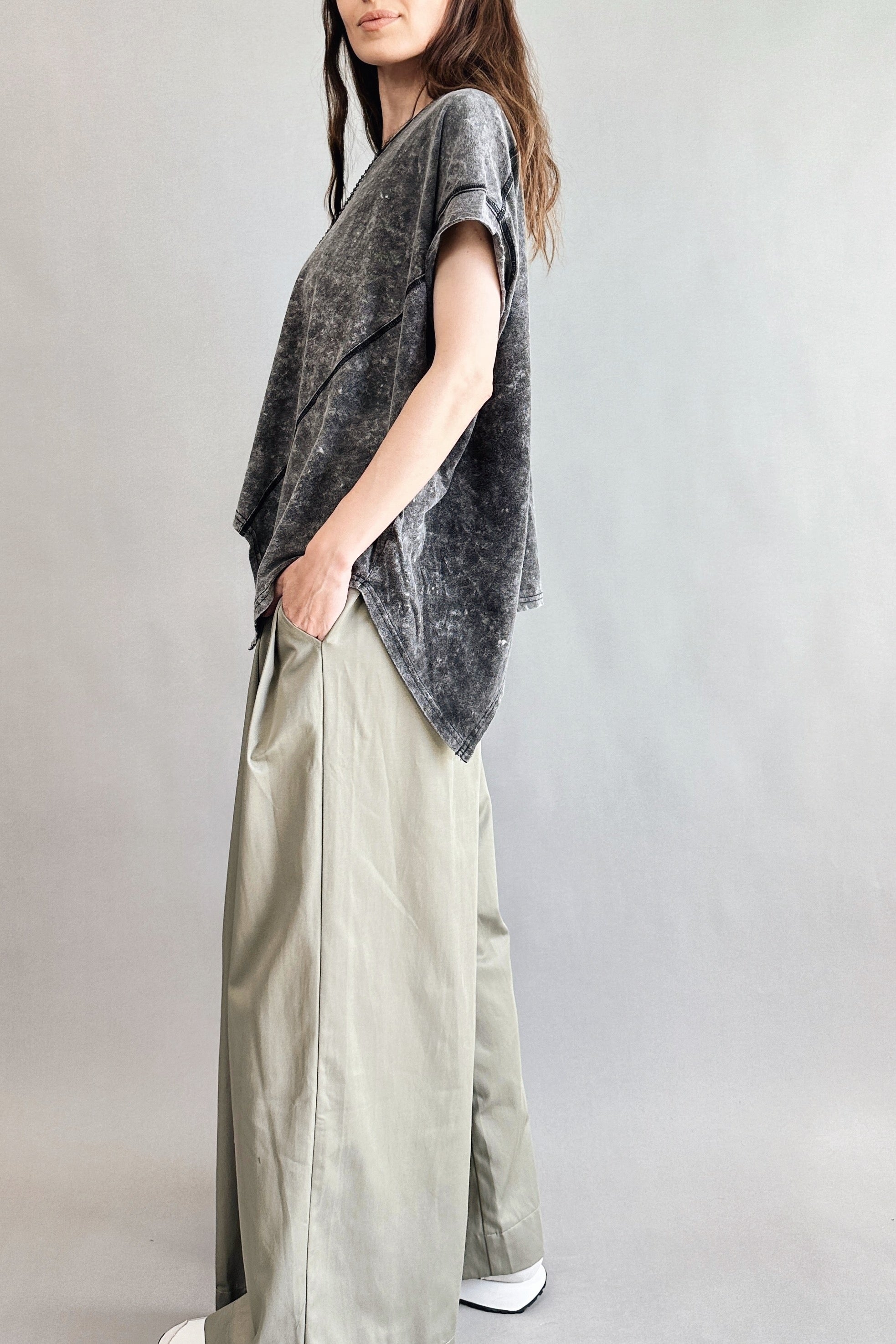 Angled side view of Trinity oversized short sleeve top in charcoal