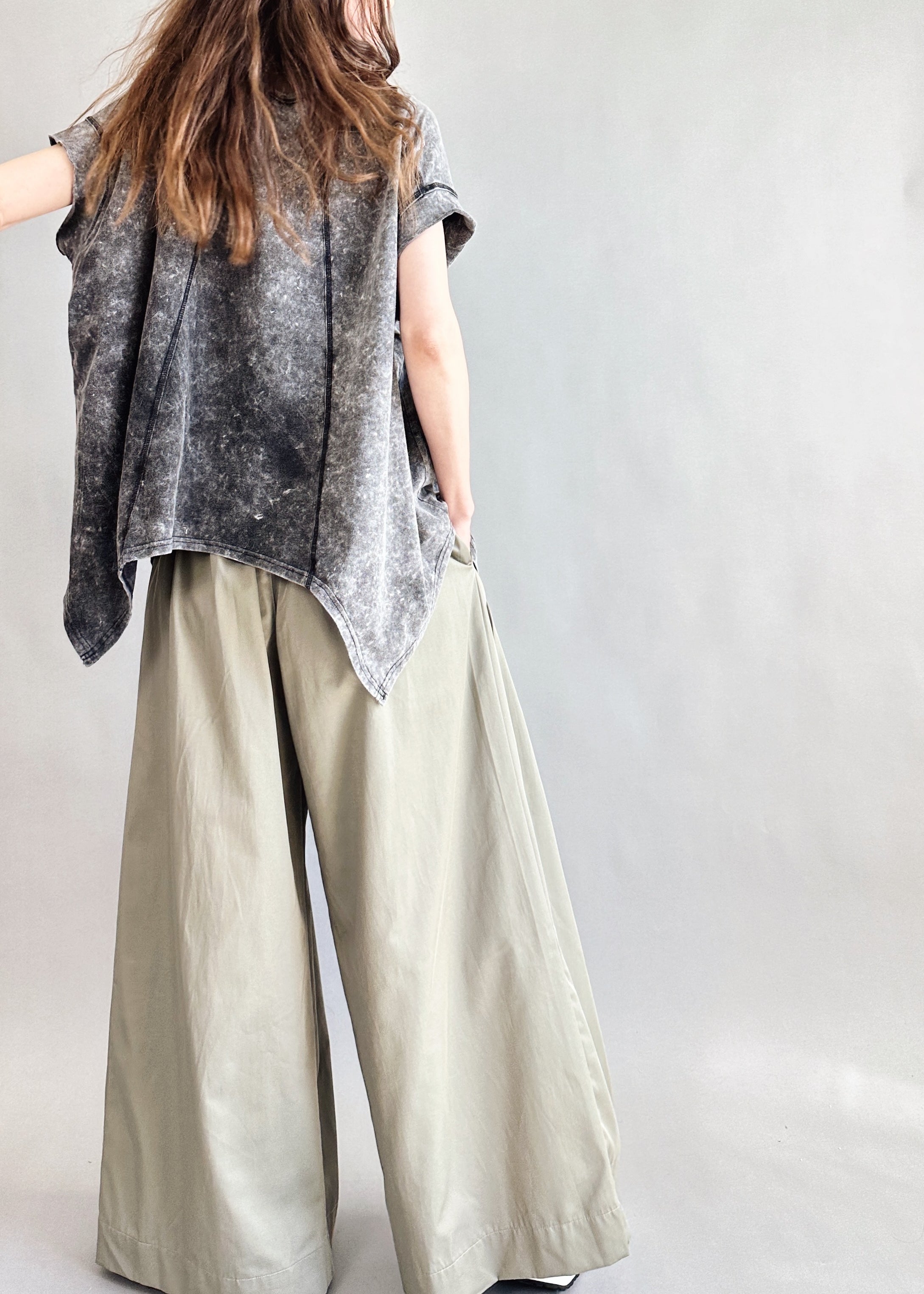 Back view of Trinity flowy oversized top with curved hem in charcoal