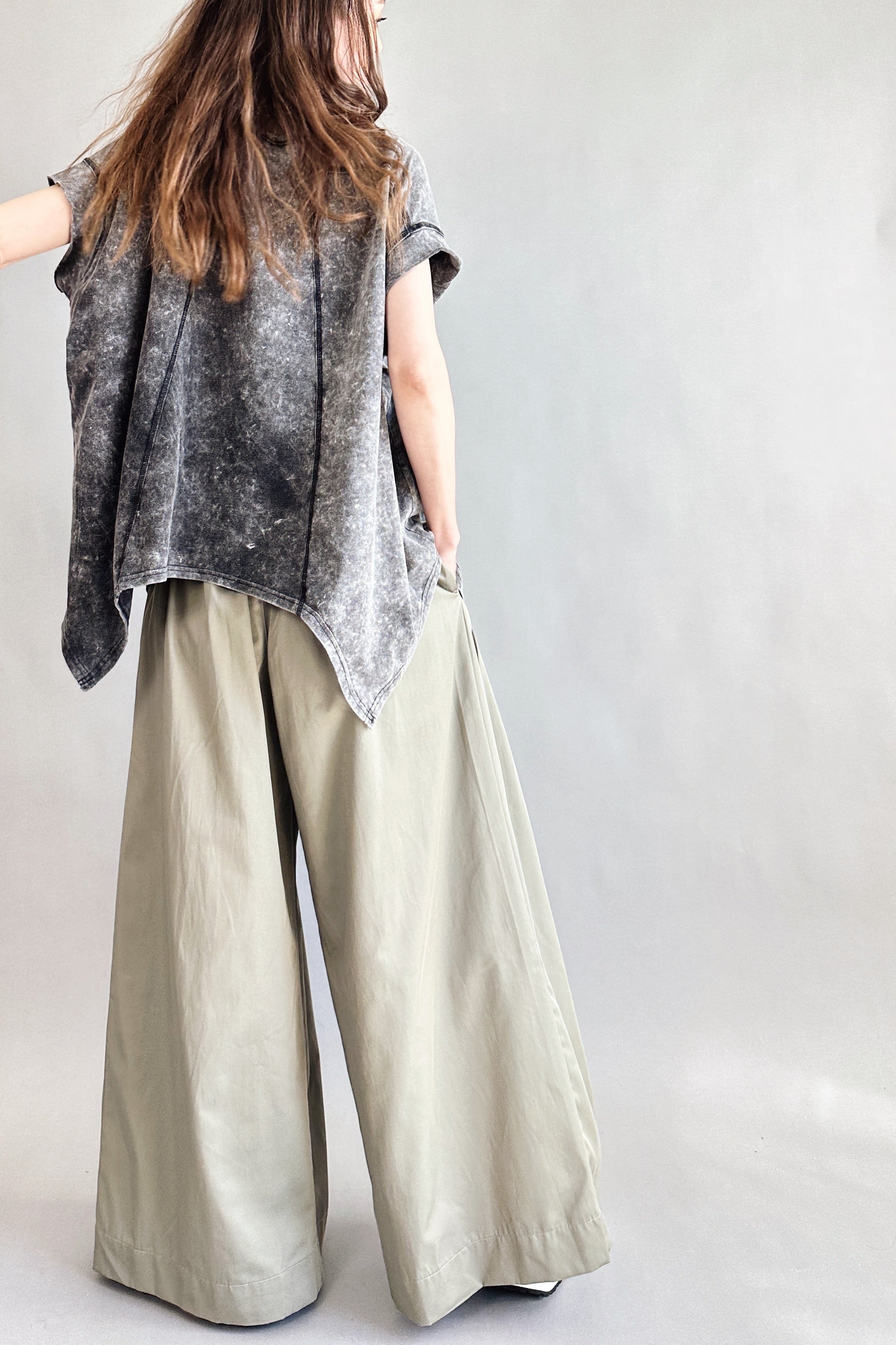 Back view of Trinity flowy oversized top with curved hem in charcoal
