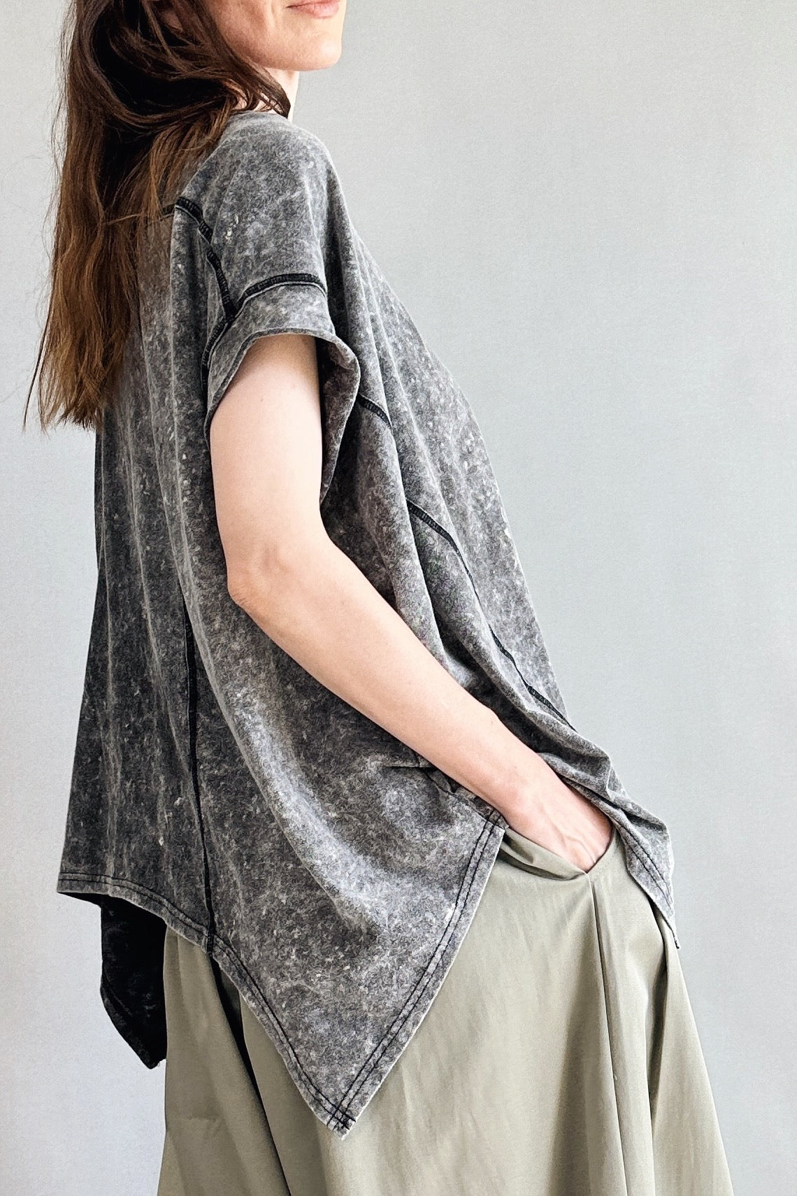 Side view of Trinity flowy oversized charcoal top showing relaxed drape