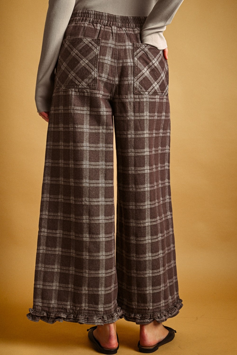 Back view of Trudy chocolate plaid pants with elastic waistband and pockets