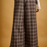 Front view of Trudy chocolate plaid wide-leg pants with ruffle hems