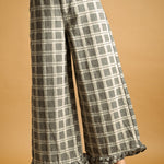 Front view of Trudy grey plaid wide-leg pants with ruffle hems