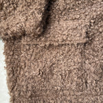 Close-up of plush teddy fabric texture on ultra soft jacket in taupe