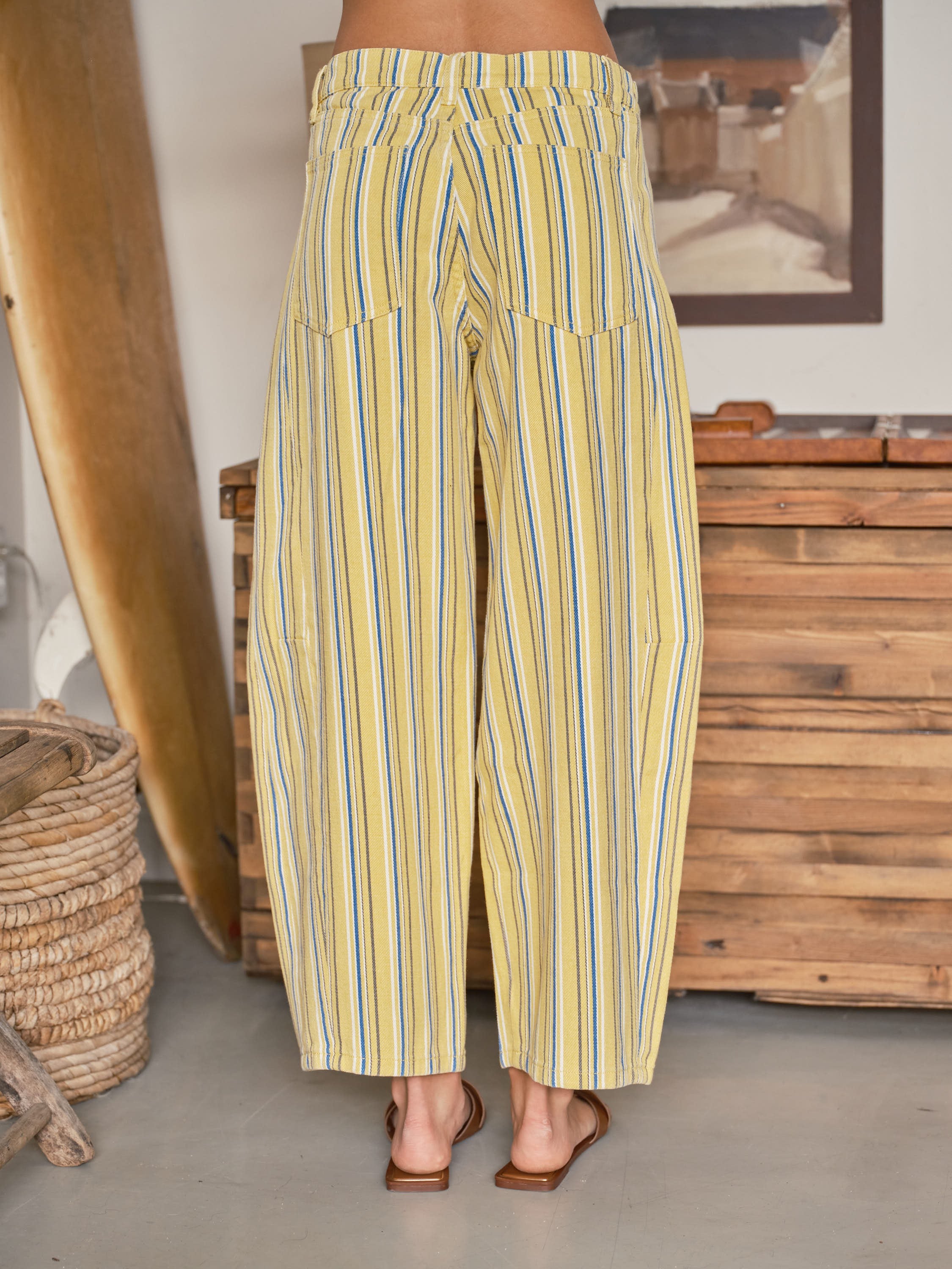 Back view of Venus Stripe Barrel Jeans in Yellow featuring vertical multi-color stripes, back pockets, and tapered barrel-leg silhouette.