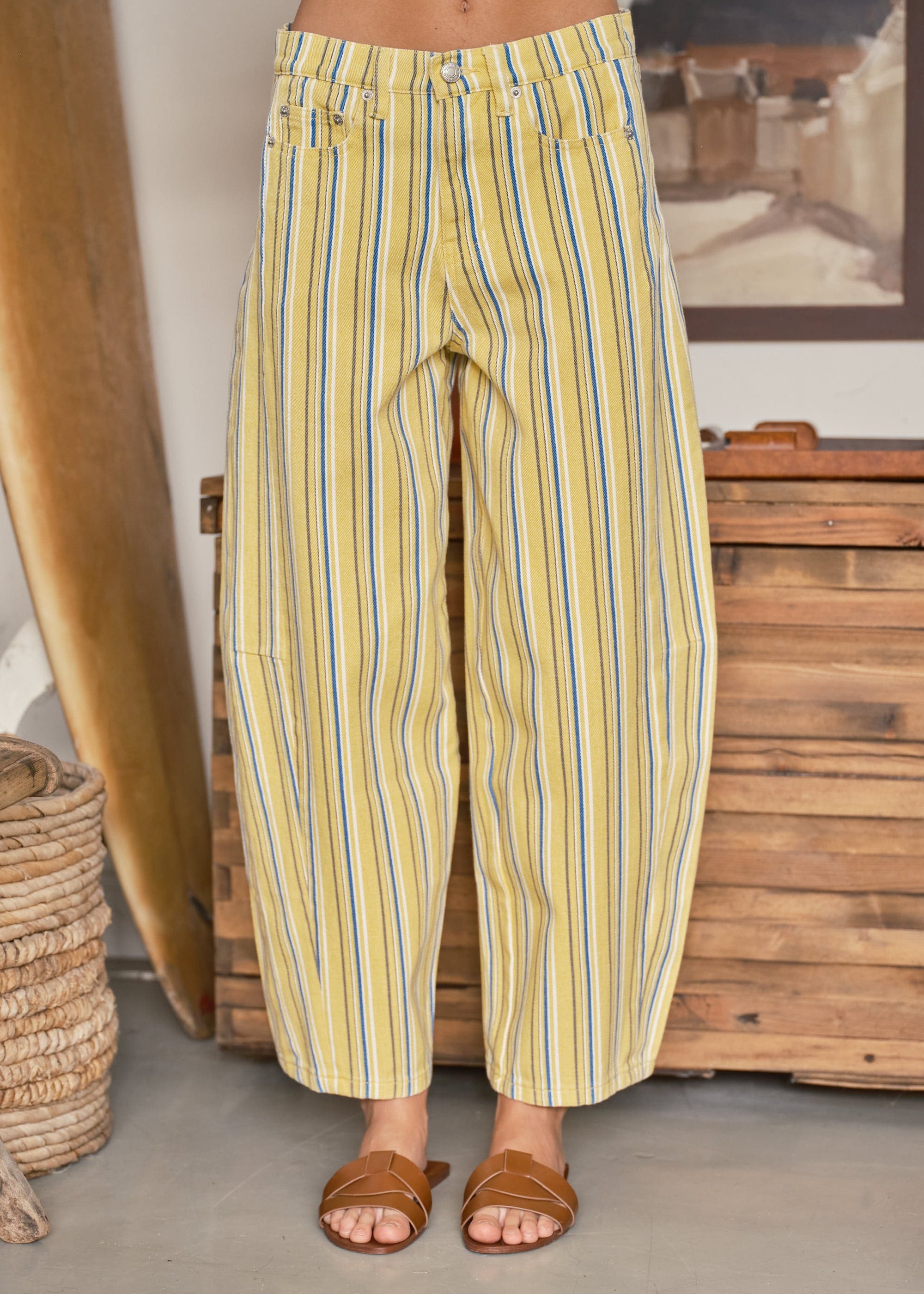 Front view of yellow striped barrel pants with a relaxed curved-leg fit