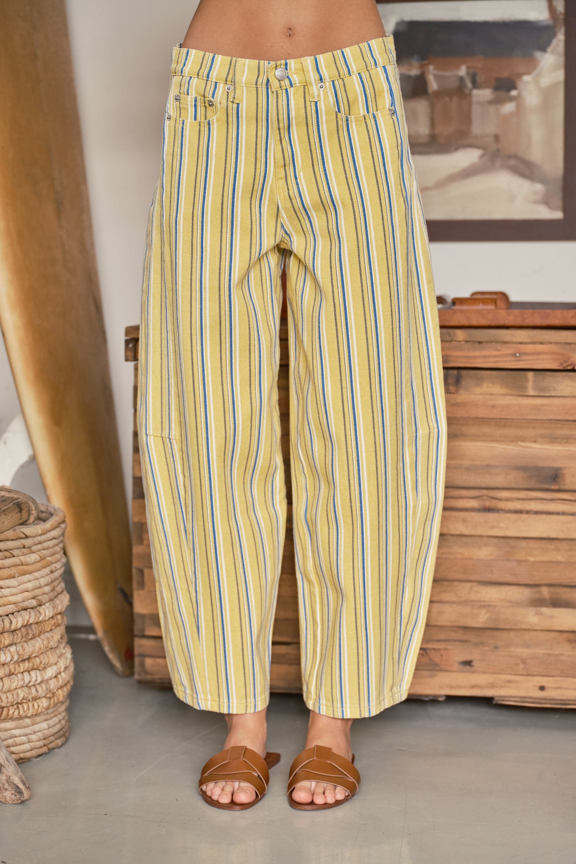 Front view of yellow striped barrel pants with a relaxed curved-leg fit