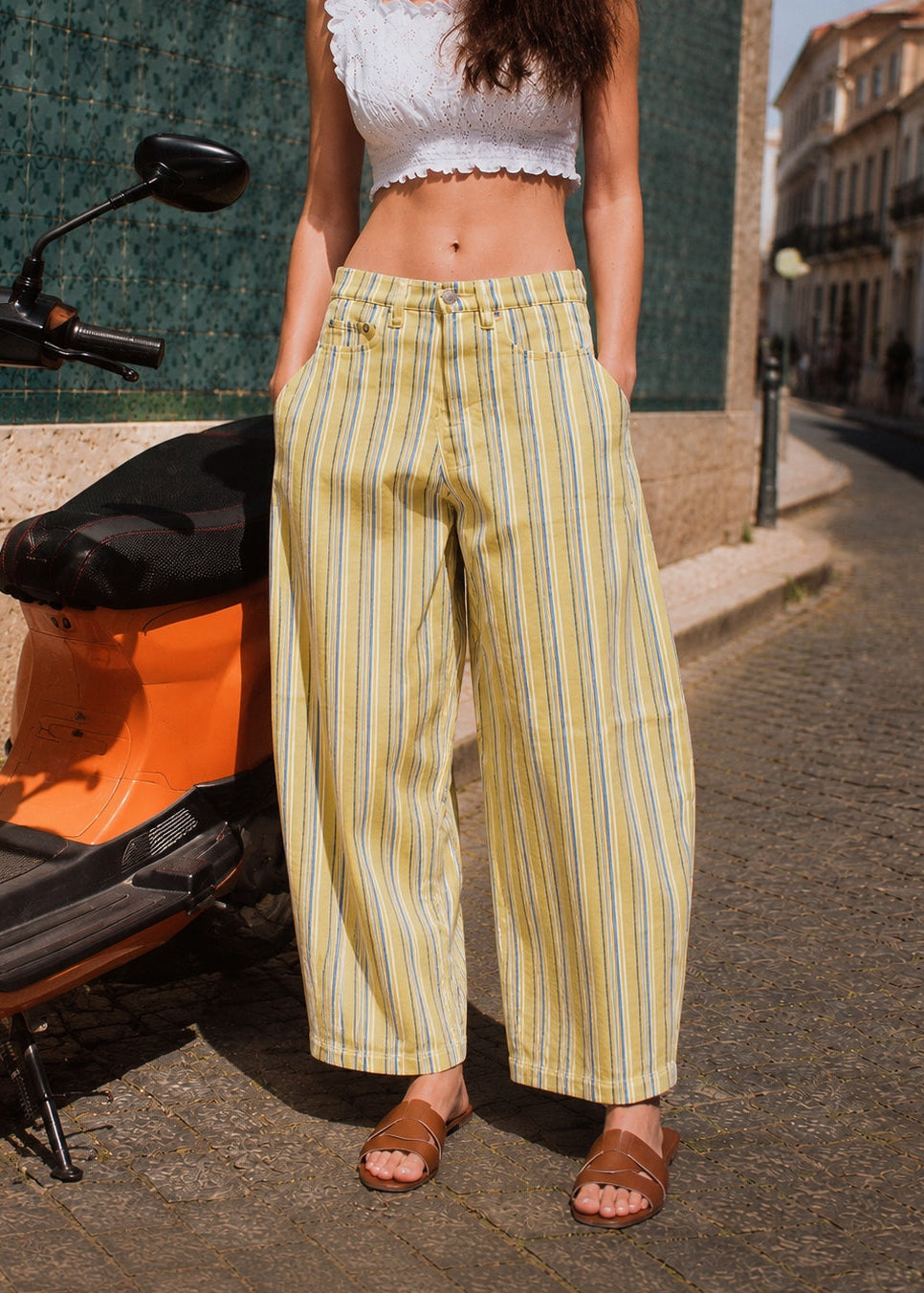 Model wearing Aaron & Amber striped barrel pants in Yellow with a white cropped top