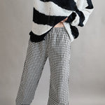 Angled front view of Wanderlust gingham boxer pants in black