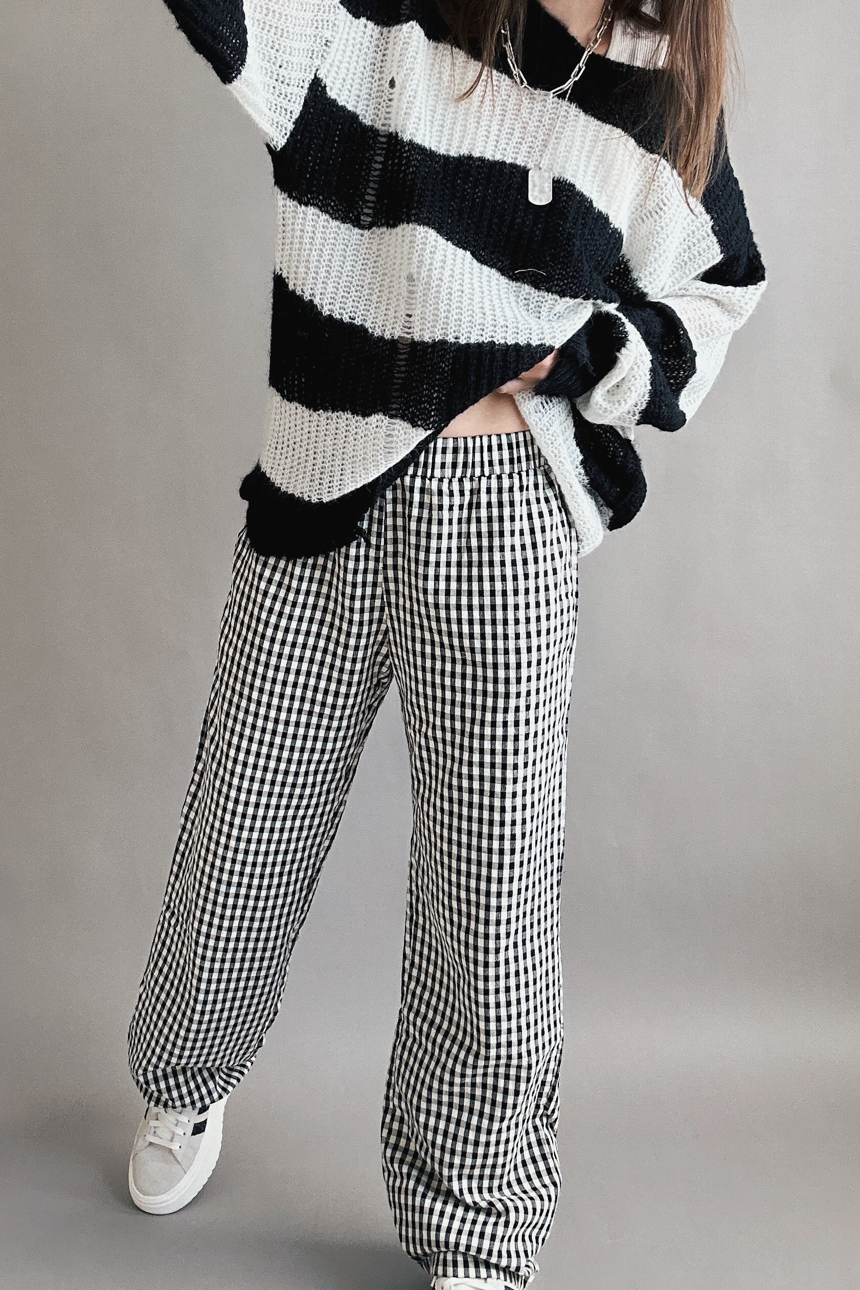 Angled front view of Wanderlust gingham boxer pants in black