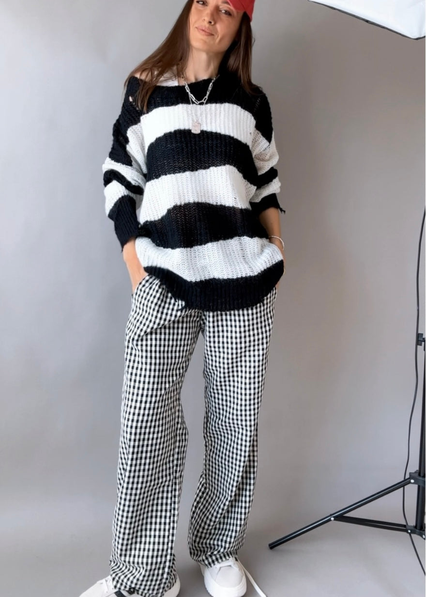 Front view of Wanderlust black gingham boxer pants styled casually