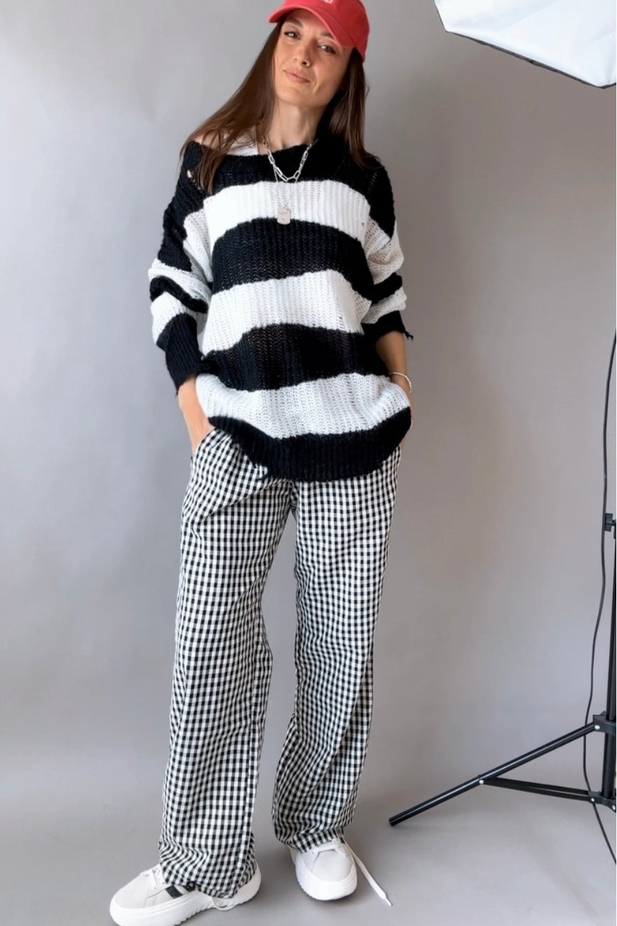 Front view of Wanderlust black gingham boxer pants styled casually