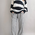 Model is wearing Wanderlust gingham boxer pants in black with elastic waistband and relaxed fit