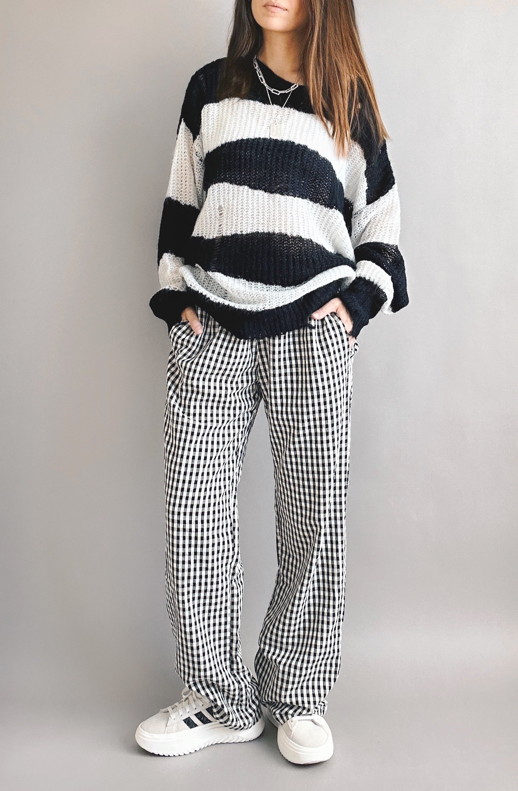 Model is wearing Wanderlust gingham boxer pants in black with elastic waistband and relaxed fit