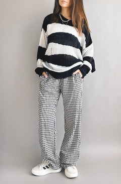 Model is wearing Wanderlust gingham boxer pants in black with elastic waistband and relaxed fit