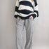Model is wearing Wanderlust gingham boxer pants in black with elastic waistband and relaxed fit