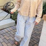 Front view of Wanderlust blue gingham boxer pants styled casually outdoors