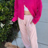 Woman wearing Wanderlust pink gingham boxer pants on a casual walk