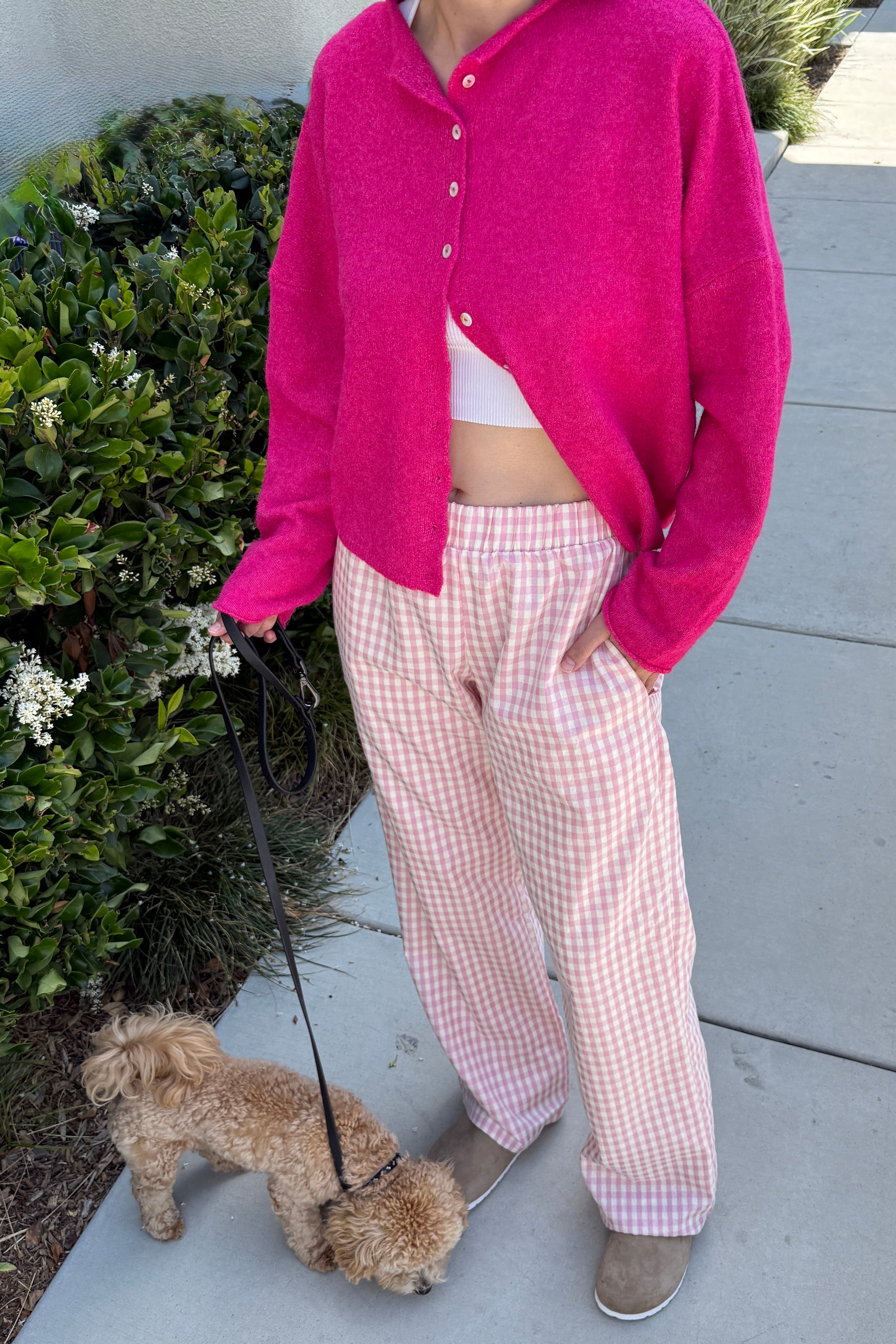 Woman wearing Wanderlust pink gingham boxer pants on a casual walk
