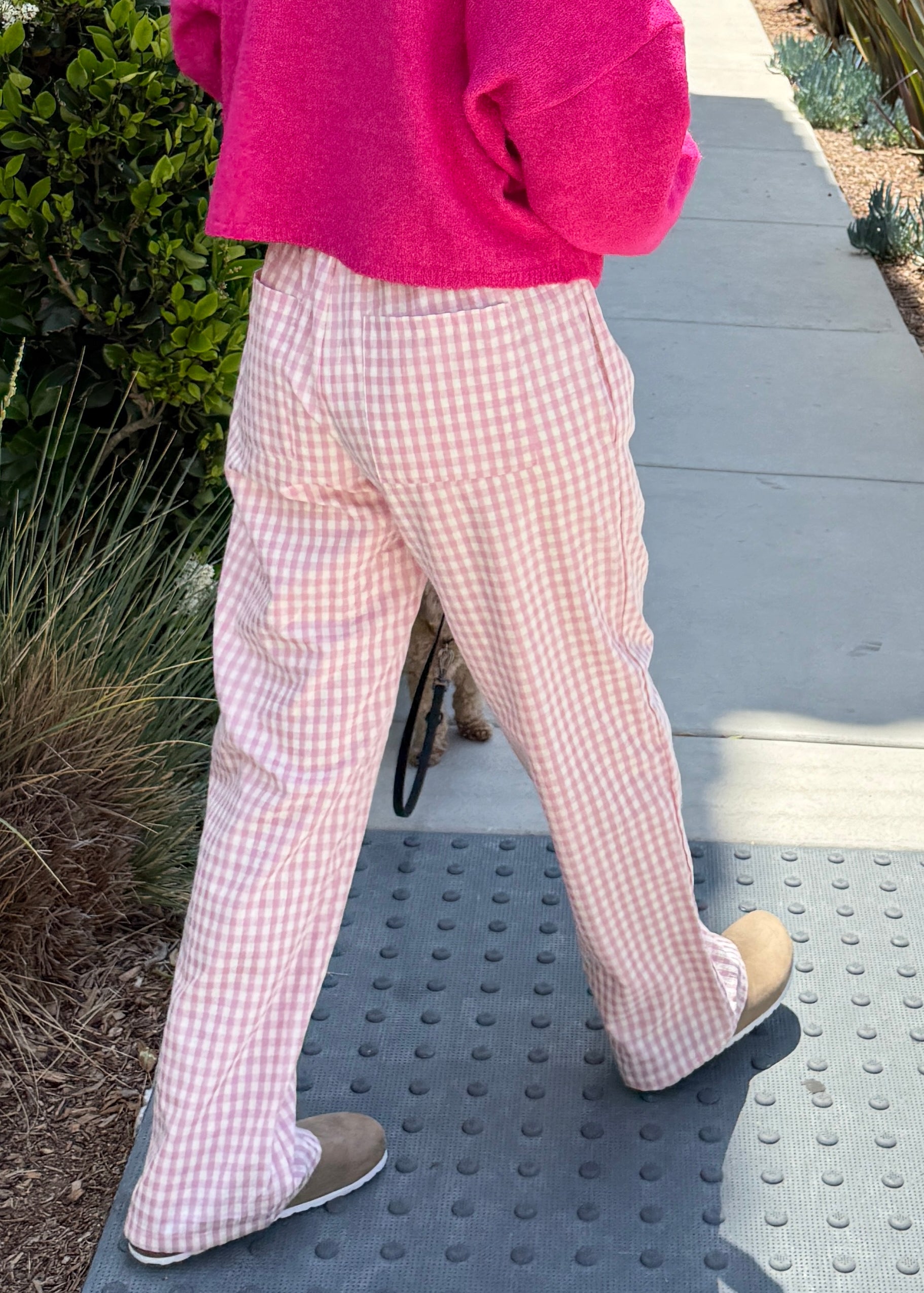 Wanderlust gingham boxer pants in pink with elastic waistband and relaxed fit - side view - walking pose