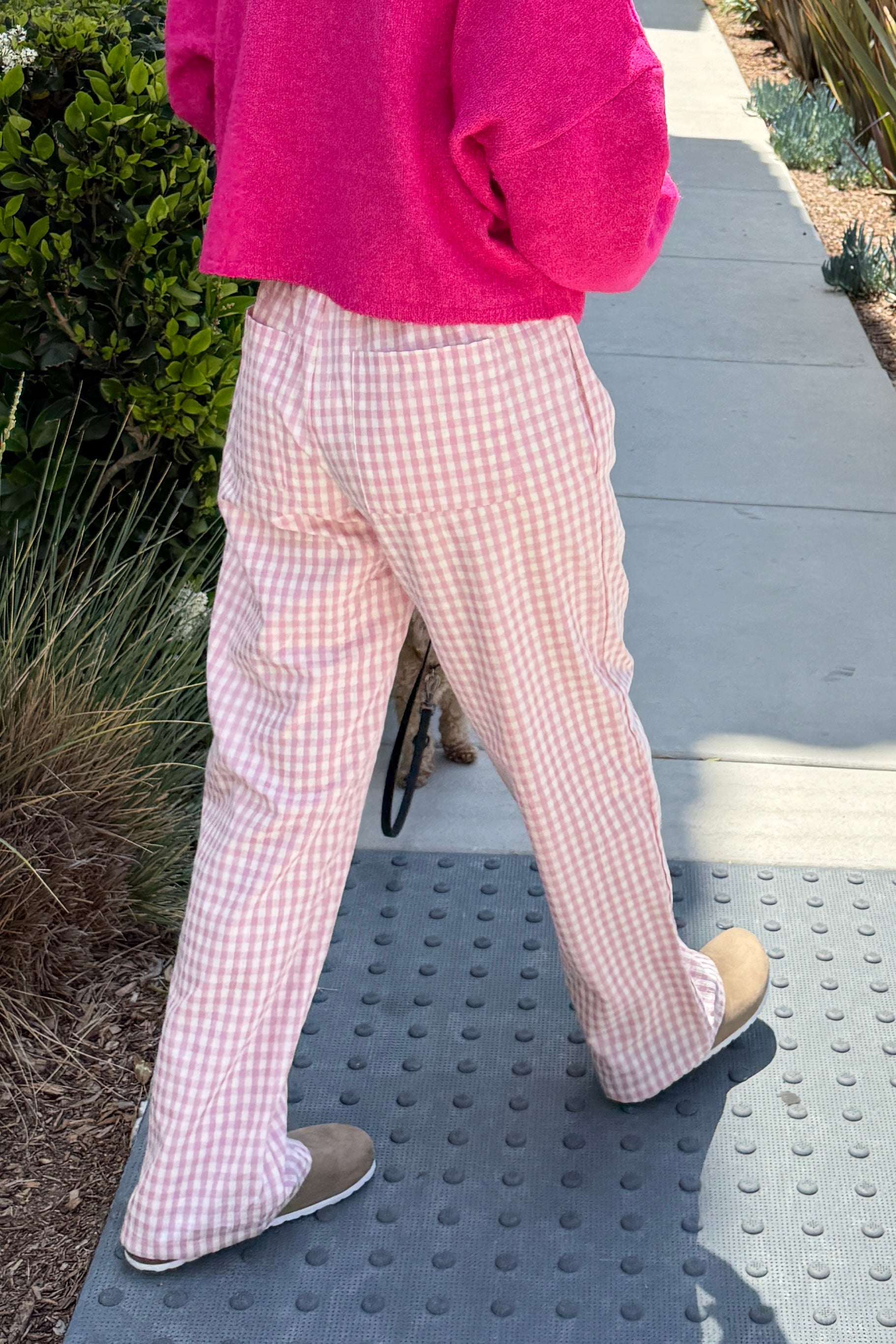 Wanderlust gingham boxer pants in pink with elastic waistband and relaxed fit - side view - walking pose