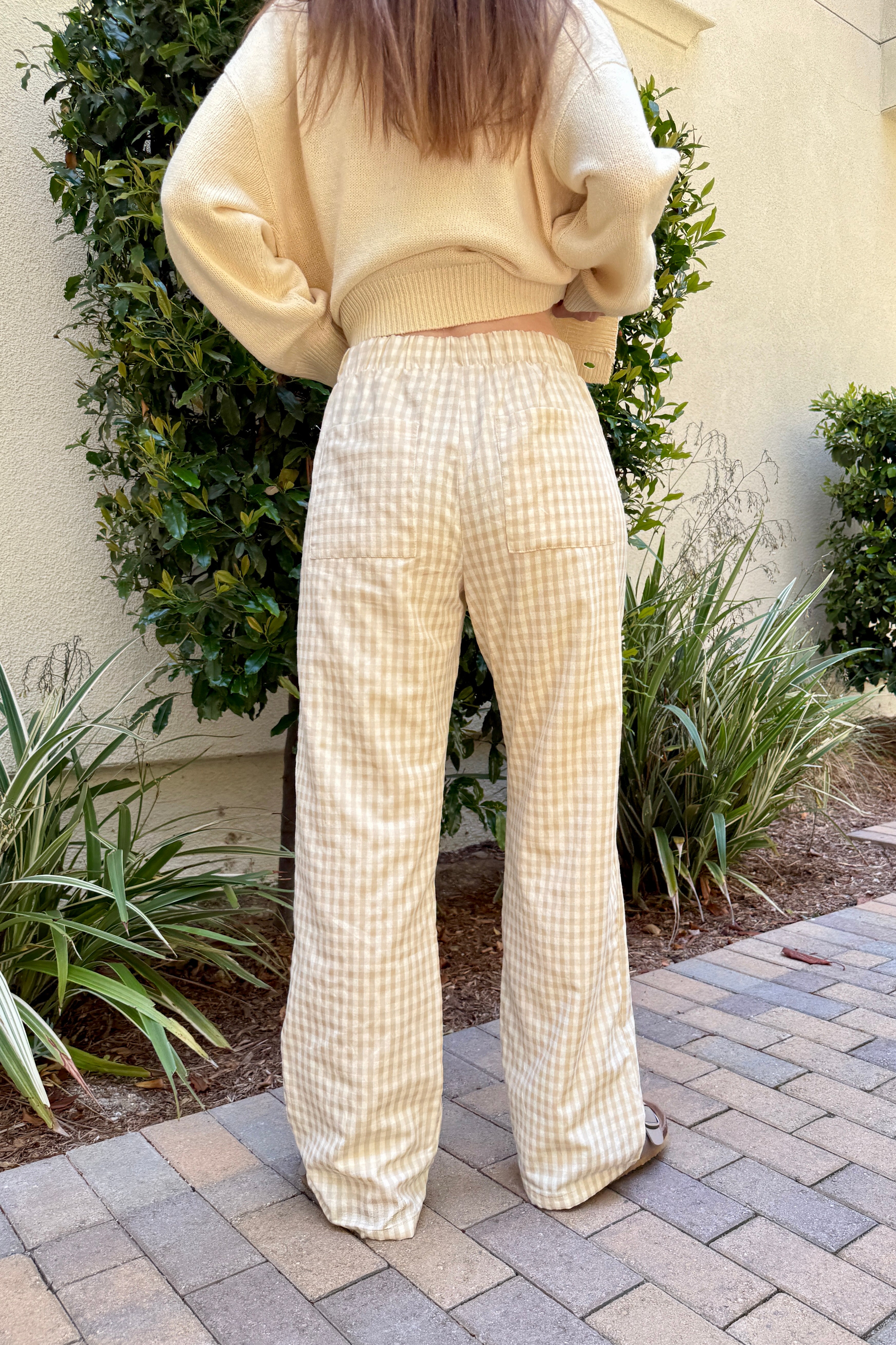 Back view of Wanderlust gingham boxer pants in yellow (oatmeal) with pocket detail