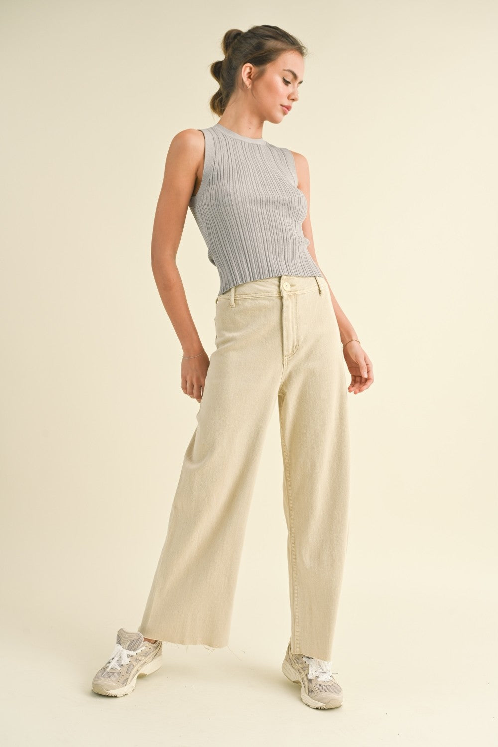 Model is wearing Wild Honey straight wide leg denim pants in beige with high-rise fit