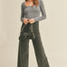 Model is wearing Wild Honey straight wide leg denim pants in washed black with high-rise fit