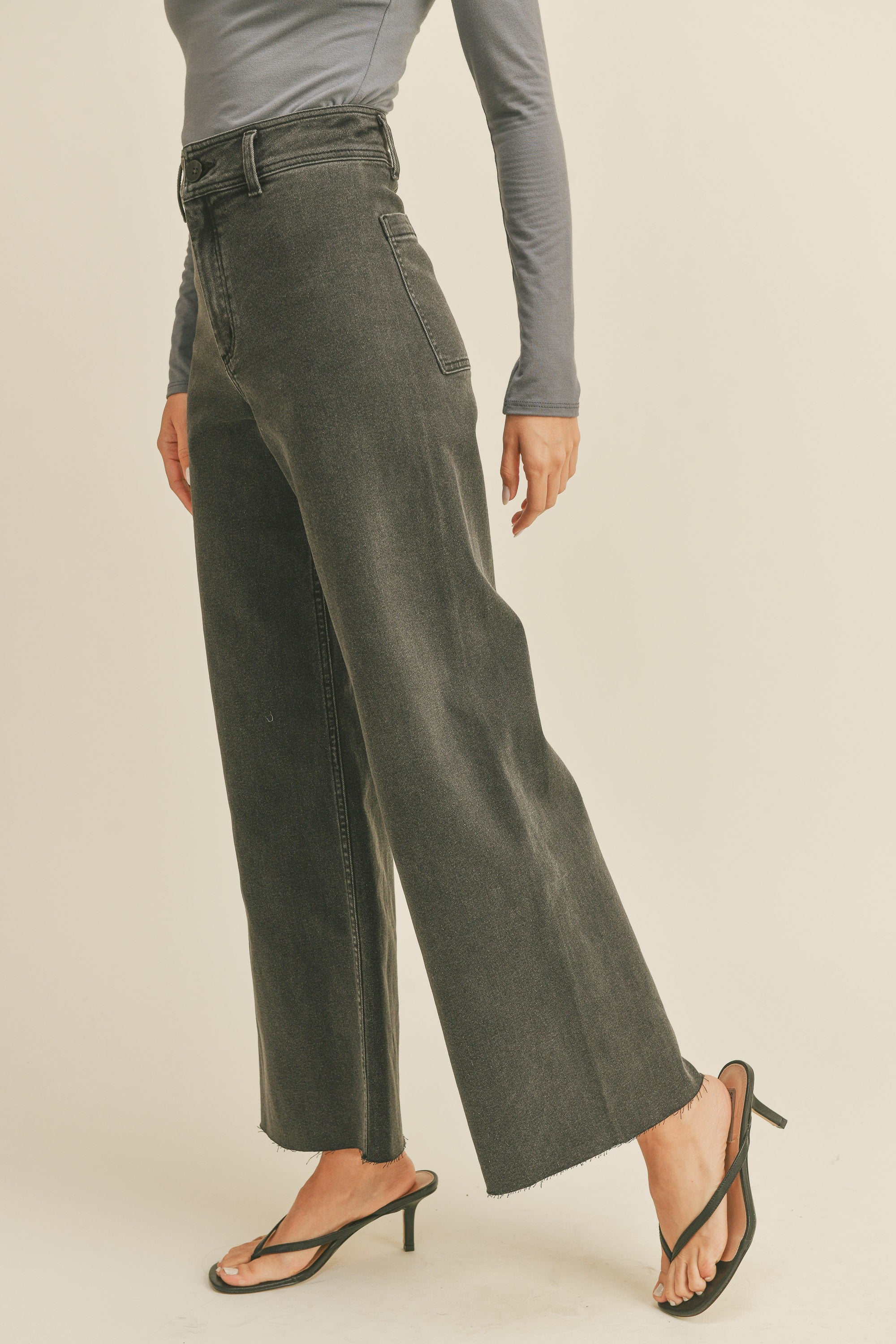 Angled front view of Wild Honey straight wide leg denim pants in washed black
