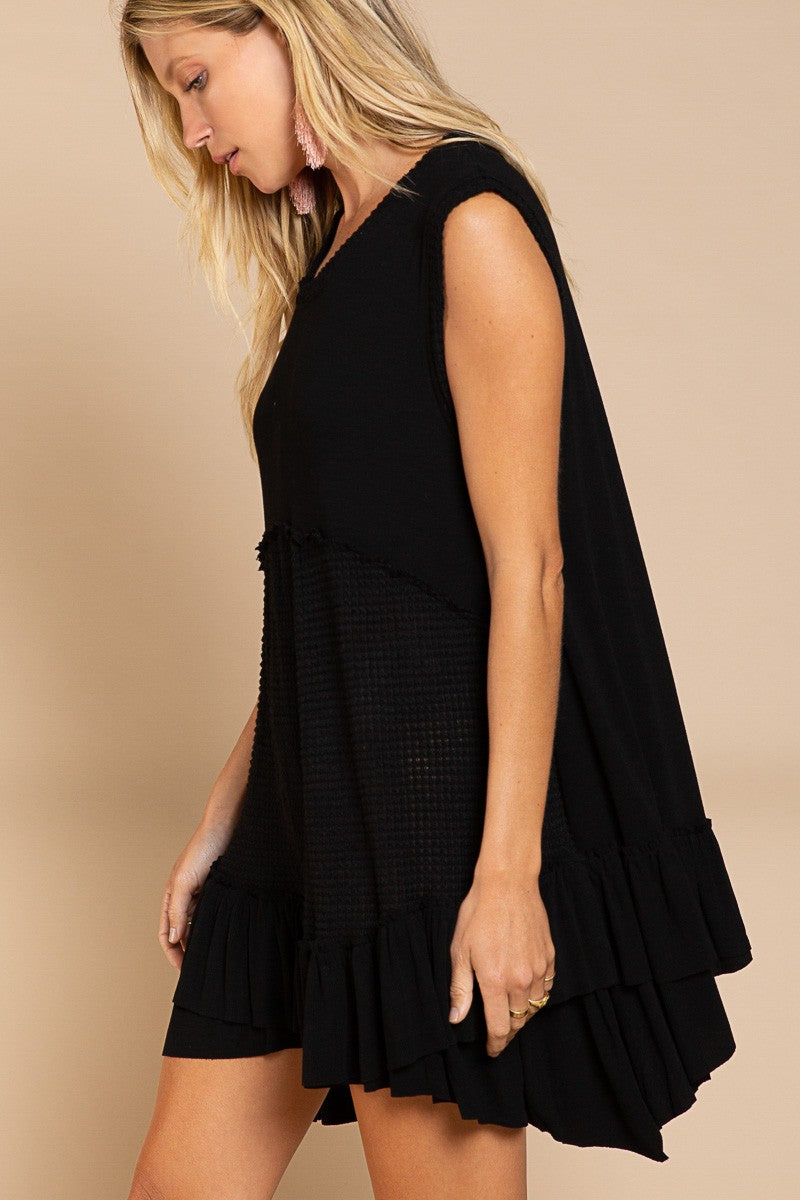 Side view of Wildest Rose tunic dress in black with sleeveless design
