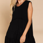 Angled front view of Wildest Rose black tunic dress showing flowy ruffle hem
